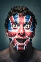 Shocked man with British flag painted on face