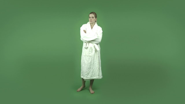 attractive caucasian girl in bathrobe isolated on green upset