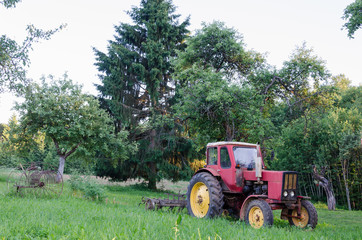 rustic farm tractor in summer garden