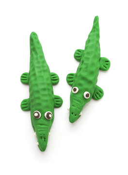 two crocodile doll from clay on white background