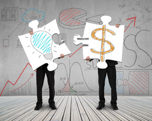 Two men connecting puzzles for idea is money concept