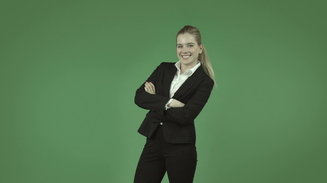 attractive caucasian business girl isolated on green with happy