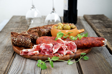Spanish tapas - jamon, chorizo ​​and olives