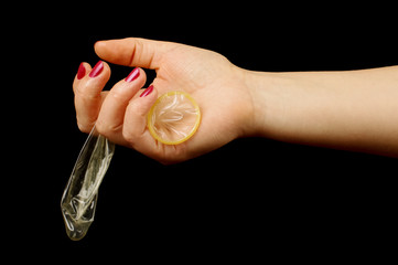 Woman hand holding condom