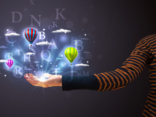 Letters and balloons in the hand of a woman