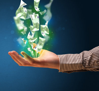 Glowing money in the hand of a businessman