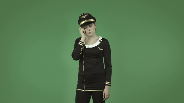 attractive caucasian air hostess isolated on green thinking