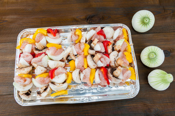 preparation for the barbecue - raw skewers on a tray