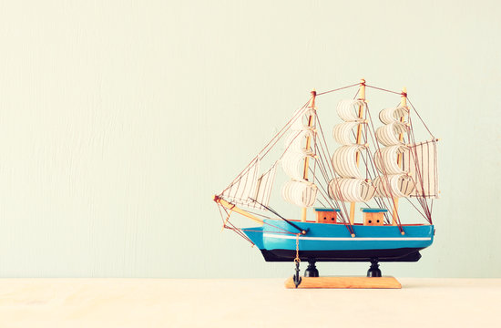 decorative boat over wooden textured background. 