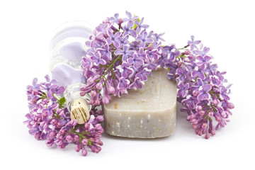 Obraz na płótnie Canvas bar of natural soap, bath salt and lilac flowers