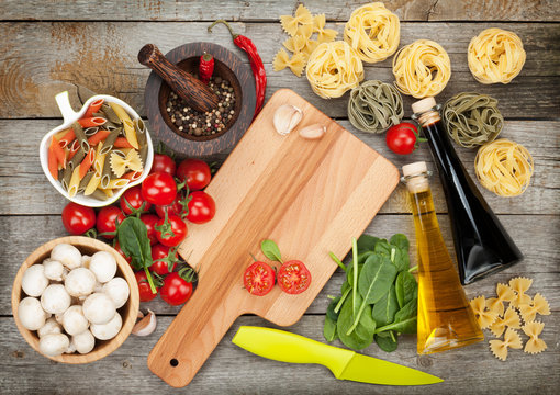 Fresh ingredients for cooking: pasta, tomato, mushroom and spice