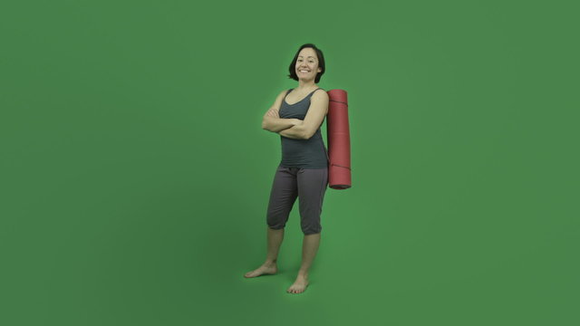caucasian sporty girl with yoga mat isolated on green screen