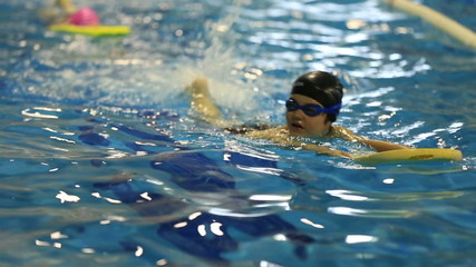 little child training in swim pool