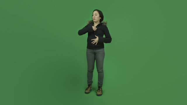 caucasian girl with winter jacket isolated on green screen warm
