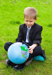 boy holding globe in the field