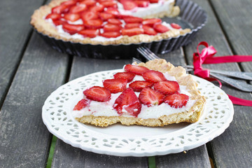 Strawberry cake on wooden tray in summer garden