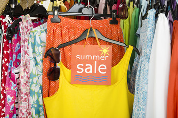 Close up on a big sale sign for summer clothes. Clearance rack.
