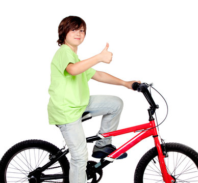 Boy standing on a bike