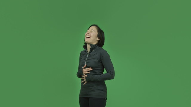 caucasian sporty girl isolated on green screen laughing funny