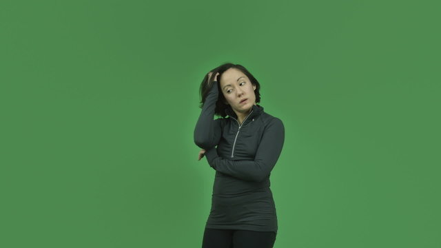 caucasian sporty girl isolated on green screen thinking