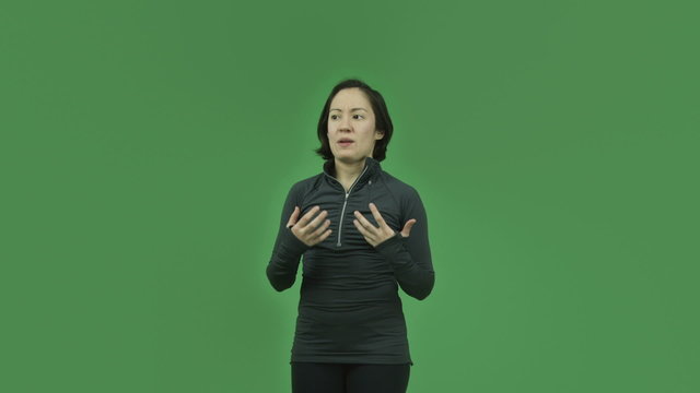 caucasian sporty girl isolated on green screen talking interview