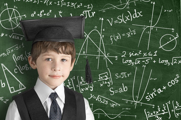 boy near blackboard with formulas