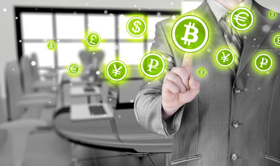 Choosing bitcoins, businessman pressing touch screen button.