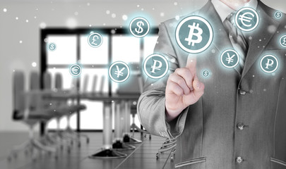 Choosing bitcoins, businessman pressing touch screen button.