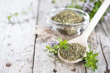 Papier Peint photo Herbes Dried Winter Savory on a cooking spoon