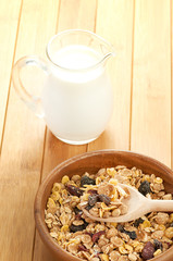 Plate with raw oatmeal on wooden table.