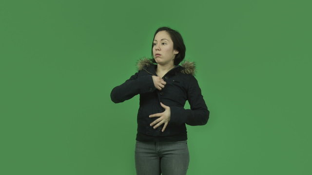 caucasian girl with winter jacket isolated on green screen warm