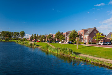 Fototapeta na wymiar Peaceful quiet suburban with expensive houses on lake in Europe