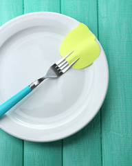 Empty note paper attached to fork,