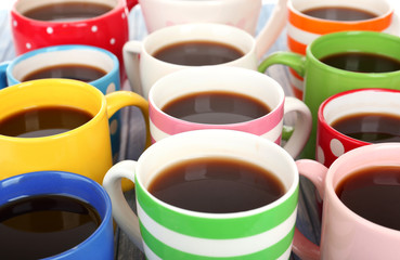 Many cups of coffee on wooden table close up