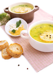 Tasty soup in saucepans, isolated on white