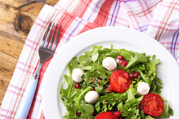 Green salad made with  arugula, tomatoes, cheese mozzarella