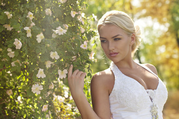 Beautiful bride with stylish make-up in white dress