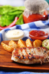 Grilled steak, grilled vegetables and fried potato pieces