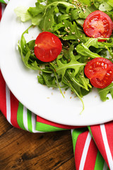 Green salad made with  arugula, tomatoes and sesame