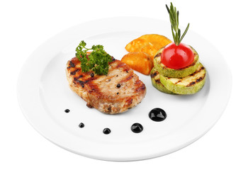 Grilled steak and grilled vegetables on plate, isolated on