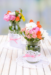 Beautiful bouquet of bright flowers in jars