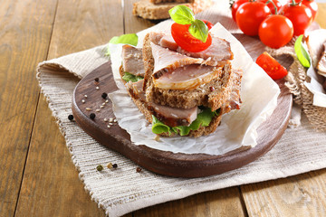 Delicious sandwiches with meet on table close-up