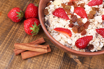 Healthy cereal with strawberry on wooden table