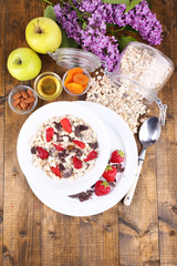 Healthy cereal with fruits on wooden table