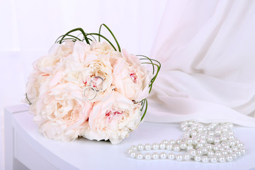 Beautiful wedding composition with bouquet on light background