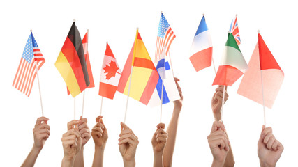Hands holding different flags, isolated on white