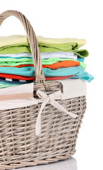 Bright clothes in laundry basket, isolated on white