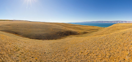 Yellow hills of Olkhon Island on Lake Baikal. panorama