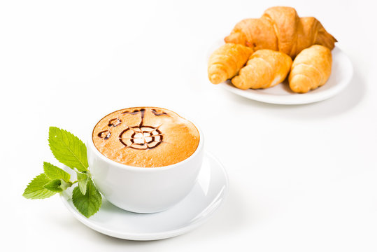 large cup of coffee and croissants on a plate