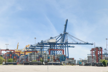 Industrial Container Cargo with working crane bridge in shipyard